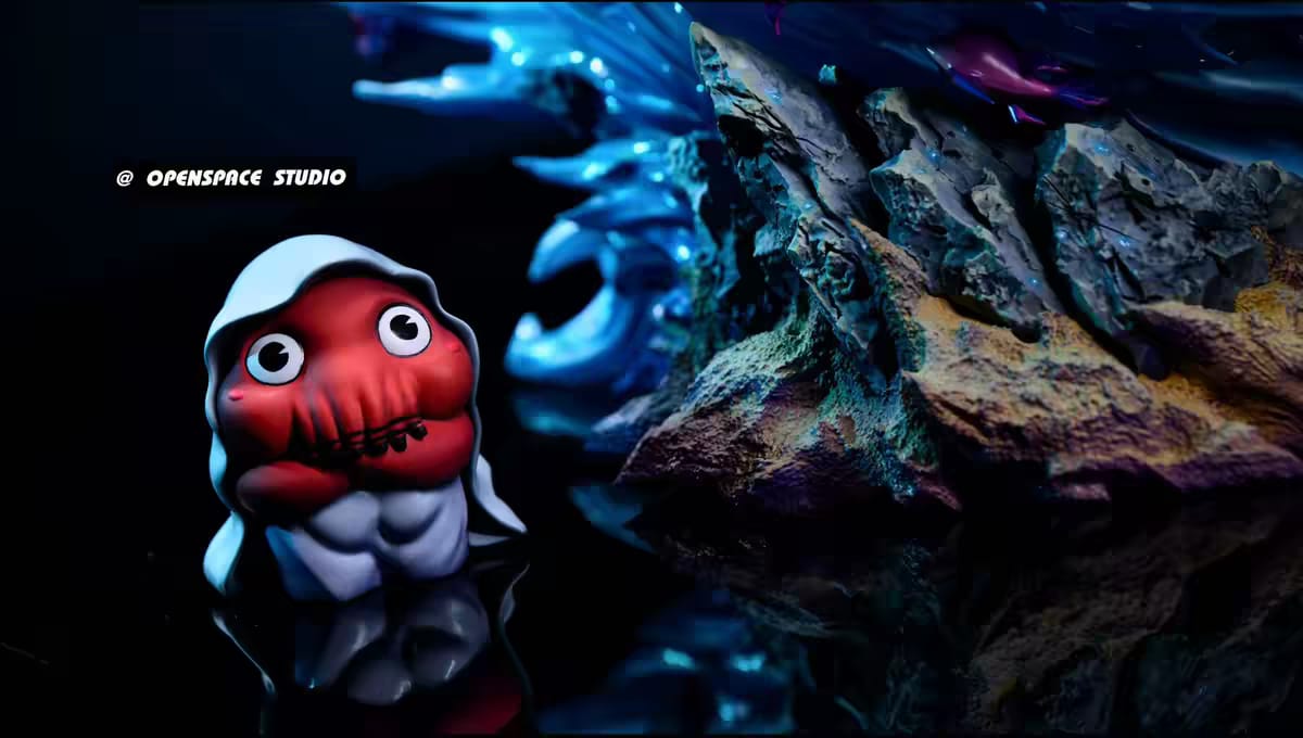 Minifigure Dagon Doll con mantello accanto alla base rocciosa del diorama
